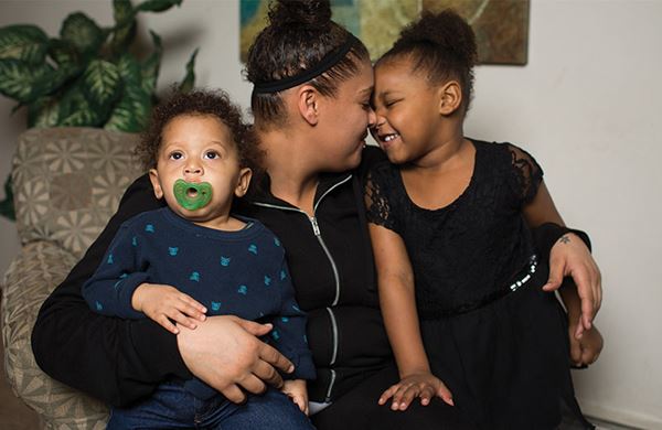 women sitting inside with her kids